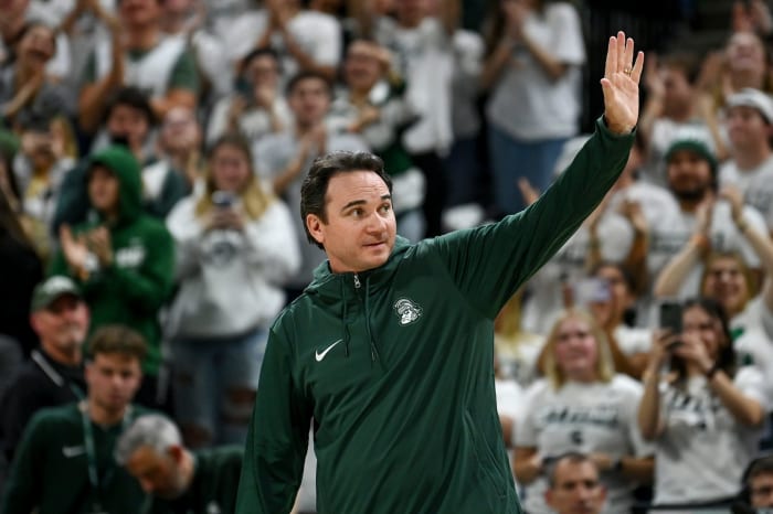 Michigan State's new football coach Jonathan Smith waves to the crowd during a timeout in the basketball game against Georgia Southern on Tuesday, Nov. 28, 2023, at the Breslin Center in East Lansing.